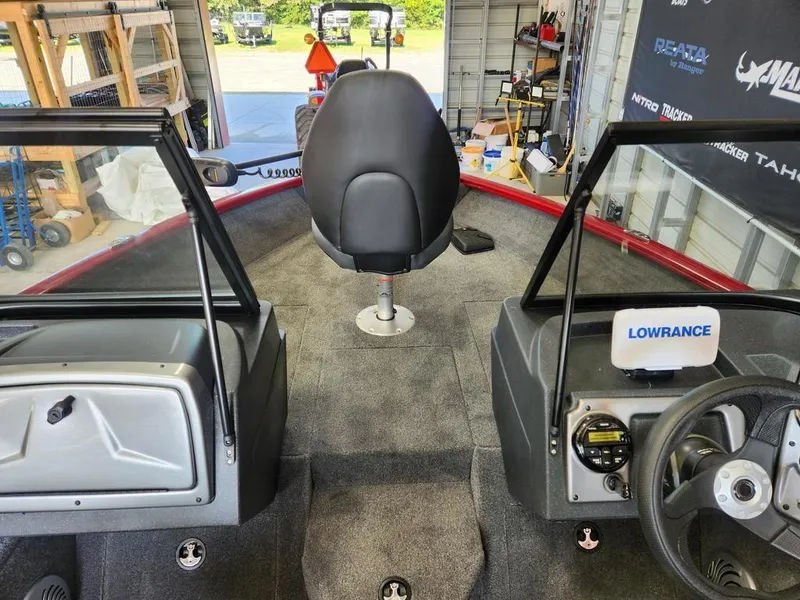 Slide: The Image of 2025 Tracker Pro Guide™ V-175 Combo interior with steering wheel and seating in a garage. - 6