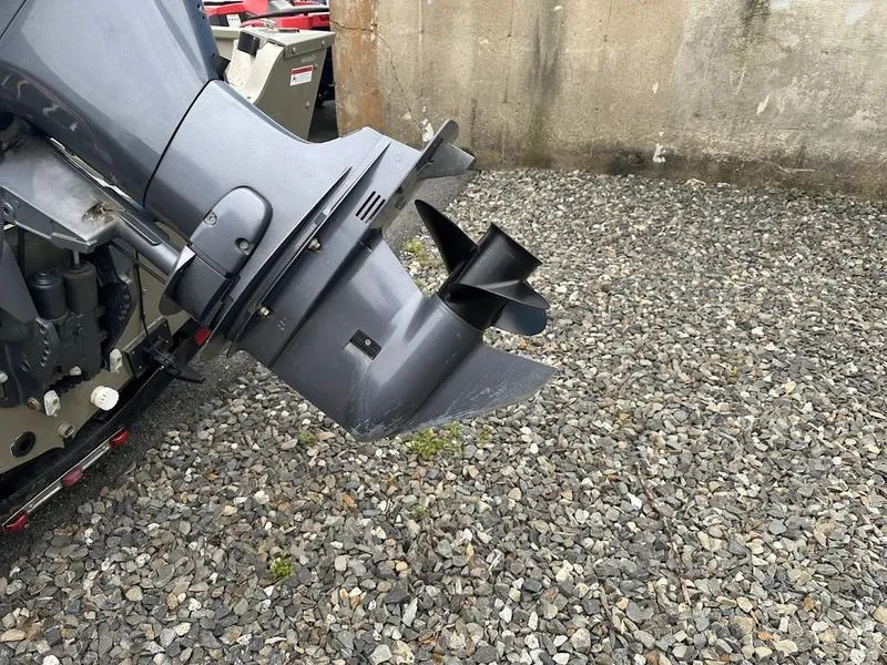 Slide: The Image of 2007 Lowe FM 165 boat motor on gravel surface. - 3