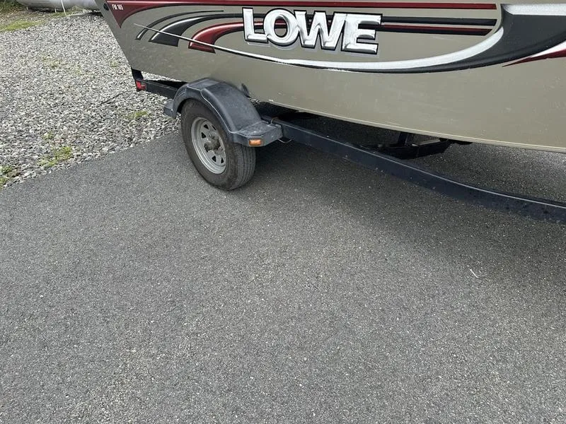 Slide: The Image of 2007 Lowe FM 165 boat on trailer, parked on asphalt. - 4