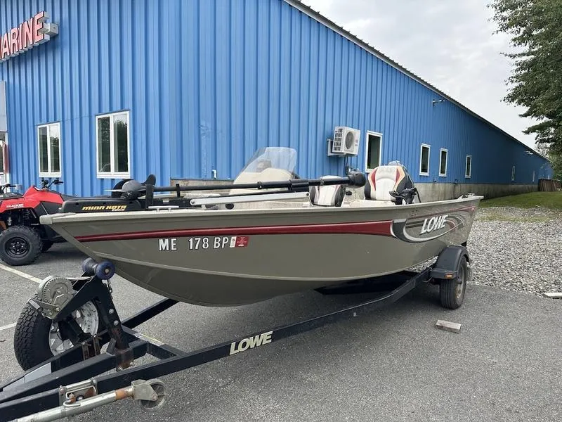 Slide: The Image of 2007 Lowe FM 165 boat on trailer outside blue building. - 5