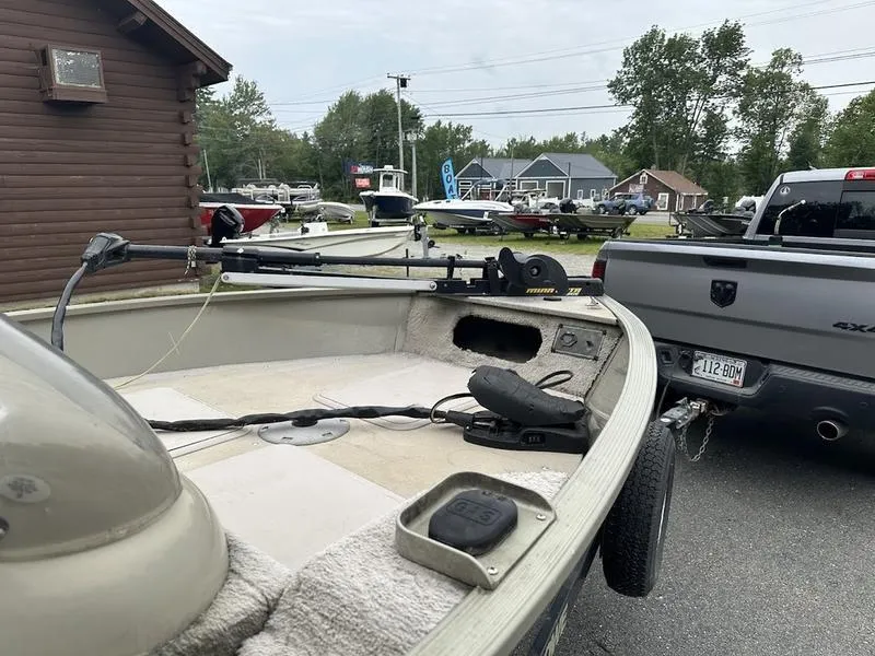 Slide: The Image of 2007 Lowe FM 165 boat hitched to a truck in a parking lot. - 6