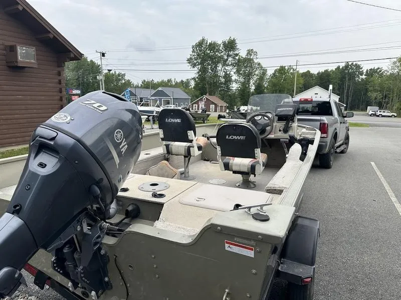 Slide: The Image of 2007 Lowe FM 165 boat on trailer with outboard motor in parking lot. - 7
