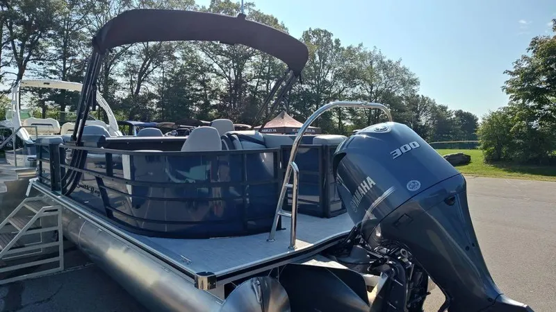 Slide: The Image of 2025 South Bay S224E 3.0 pontoon boat with Yamaha 300 engine, parked outdoors. - 6