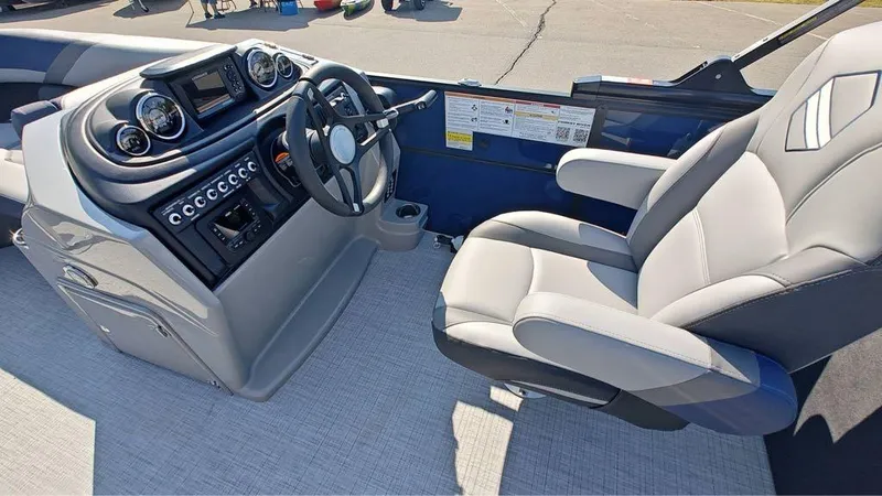 Slide: The Image of 2025 South Bay S224E 3.0 boat interior with modern dashboard and comfortable captain's chair. - 7