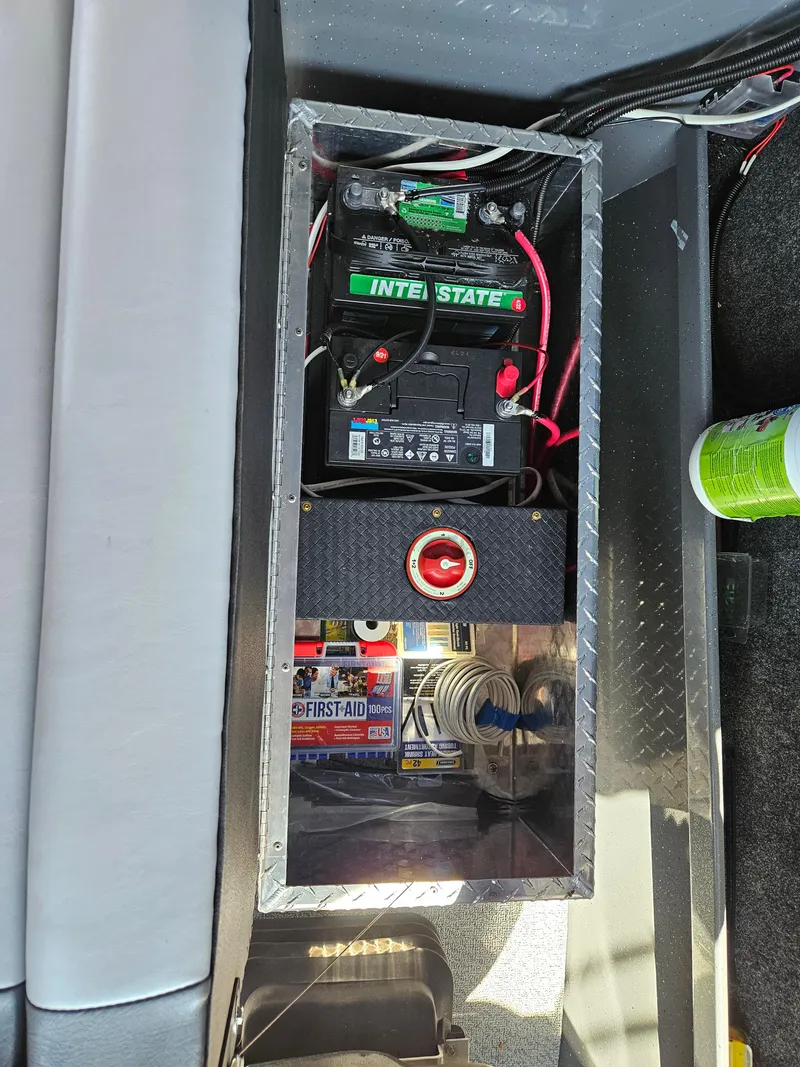 Slide: The Image of Battery compartment of 2022 RH Boats Coastal 22 Hardtop with wiring and first aid kit. - 10