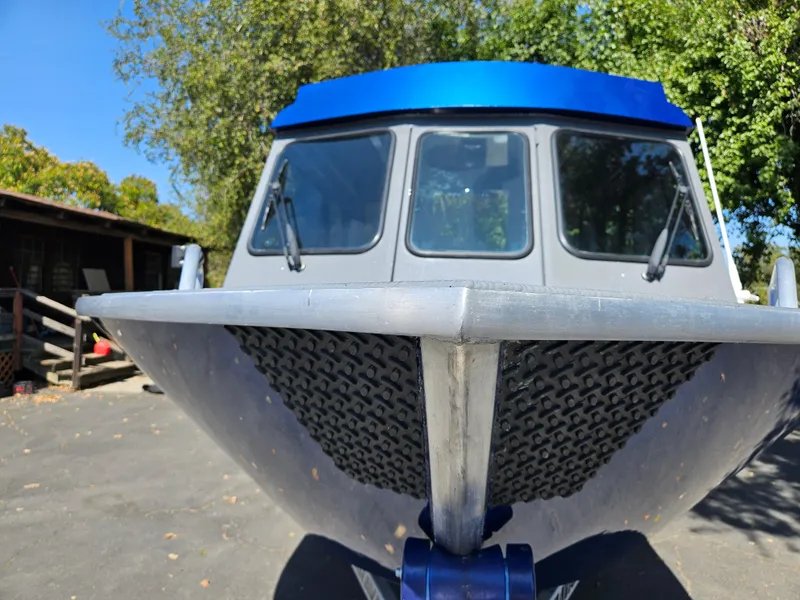 Slide: The Image of 2022 RH Boats Coastal 22 Hardtop, front view, parked outdoors. - 11