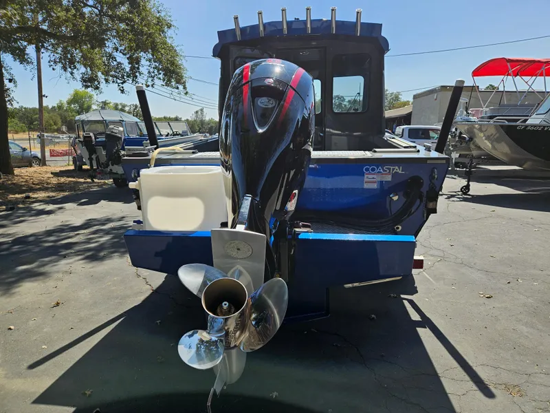 Slide: The Image of 2022 RH Boats Coastal 22 Hardtop with powerful outboard motor, parked outdoors. - 3
