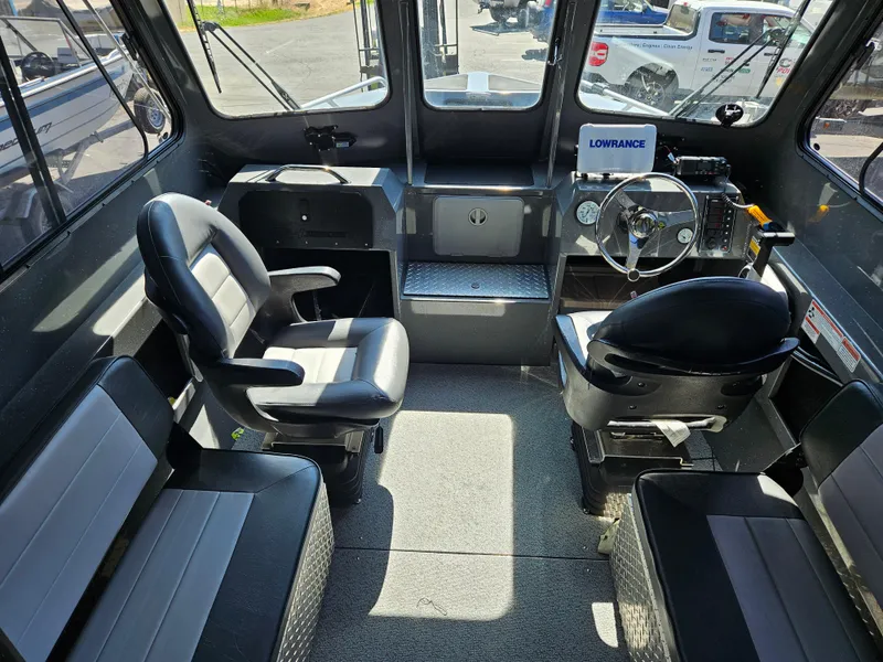 Slide: The Image of Interior of 2022 RH Boats Coastal 22 Hardtop, featuring seating and steering console. - 7
