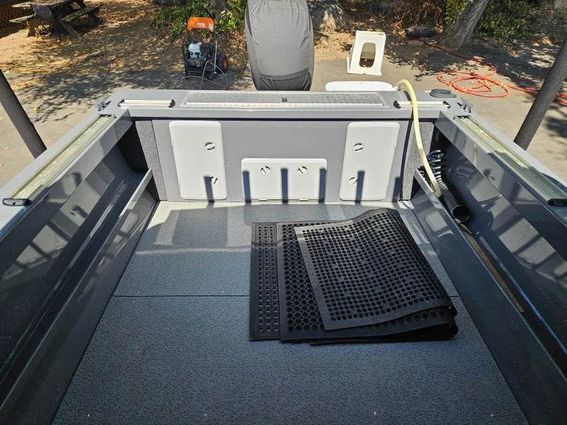 Slide: The Image of 2022 RH Boats Coastal 22 Hardtop interior with rubber mats and storage compartments. - 8