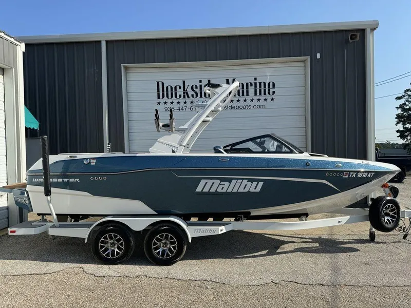 Slide: The Image of 2022 Malibu 23 LSV boat on trailer at Dockside Marine dealership. - 0