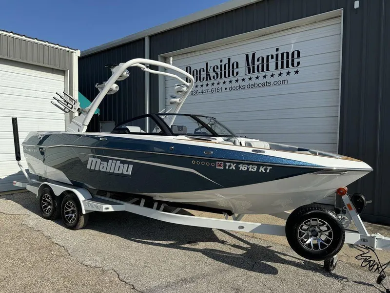 Slide: The Image of 2022 Malibu 23 LSV boat on trailer at Dockside Marine dealership. - 1