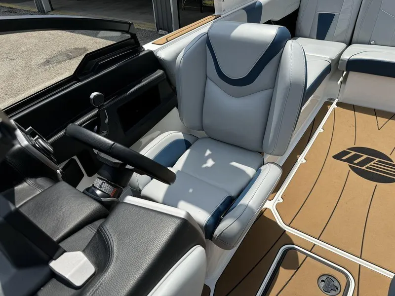 Slide: The Image of 2022 Malibu 23 LSV boat interior with sleek seating and modern dashboard design. - 11