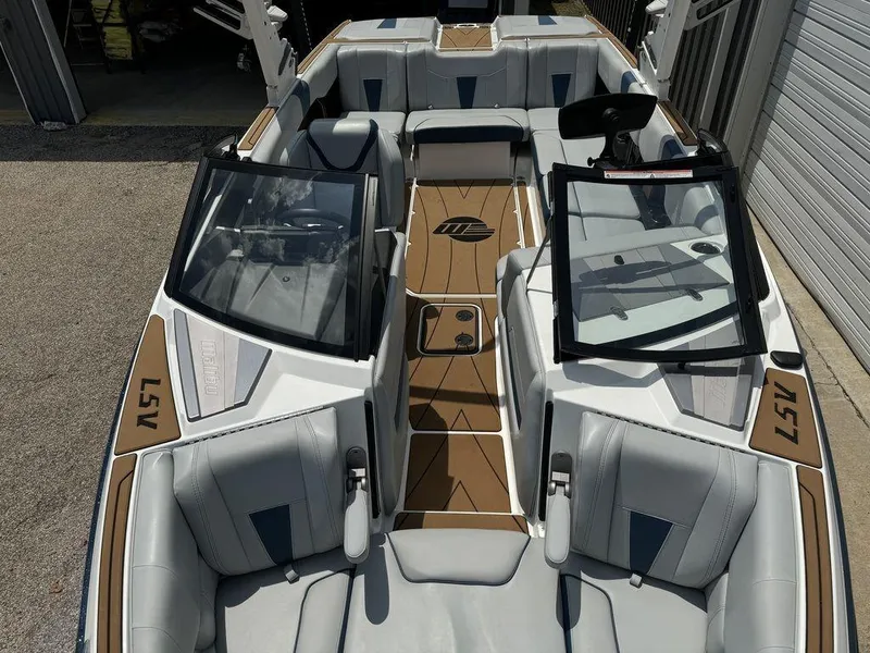 Slide: The Image of 2022 Malibu 23 LSV boat interior with sleek seating and modern design. - 7