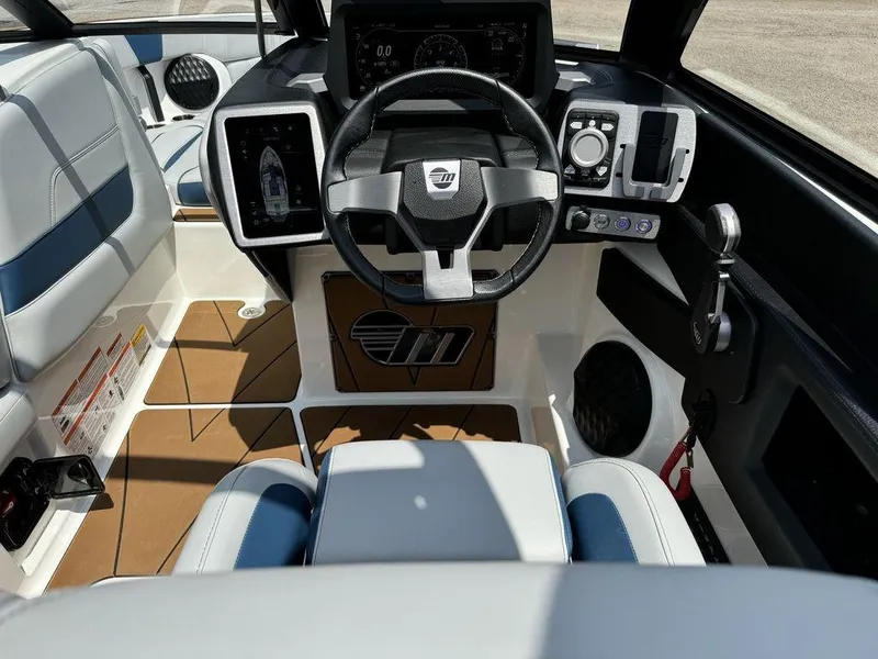 Slide: The Image of 2022 Malibu 23 LSV boat interior with modern dashboard and steering wheel. - 8
