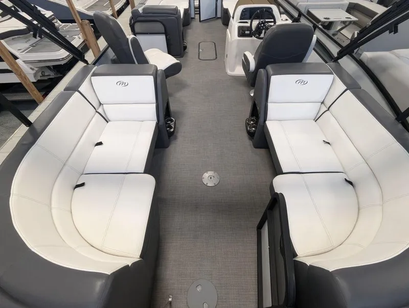 Slide: The Image of 2022 Manitou 23 Aurora LE RF VP pontoon boat interior with white seating and gray flooring. - 6