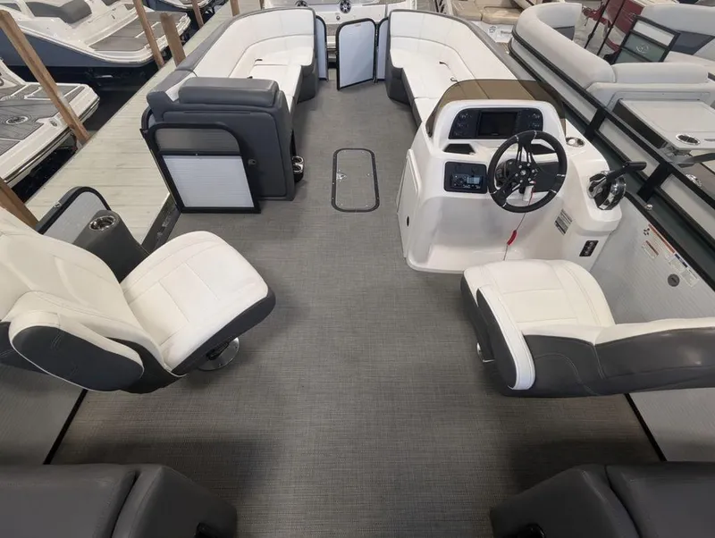 Slide: The Image of 2022 Manitou 23 Aurora LE RF VP pontoon boat interior with modern seating and helm. - 7