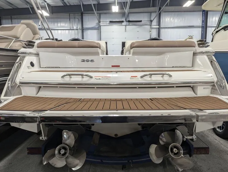 Slide: The Image of 2014 Cobalt 296 boat stern with teak swim platform and dual propellers in a showroom. - 4