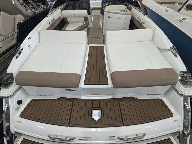 Slide: The Image of 2014 Cobalt 296 boat interior with white and brown seating, wood-style flooring. - 5