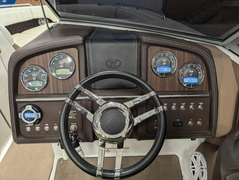 Slide: The Image of 2014 Cobalt 296 boat dashboard with steering wheel and gauges. - 9