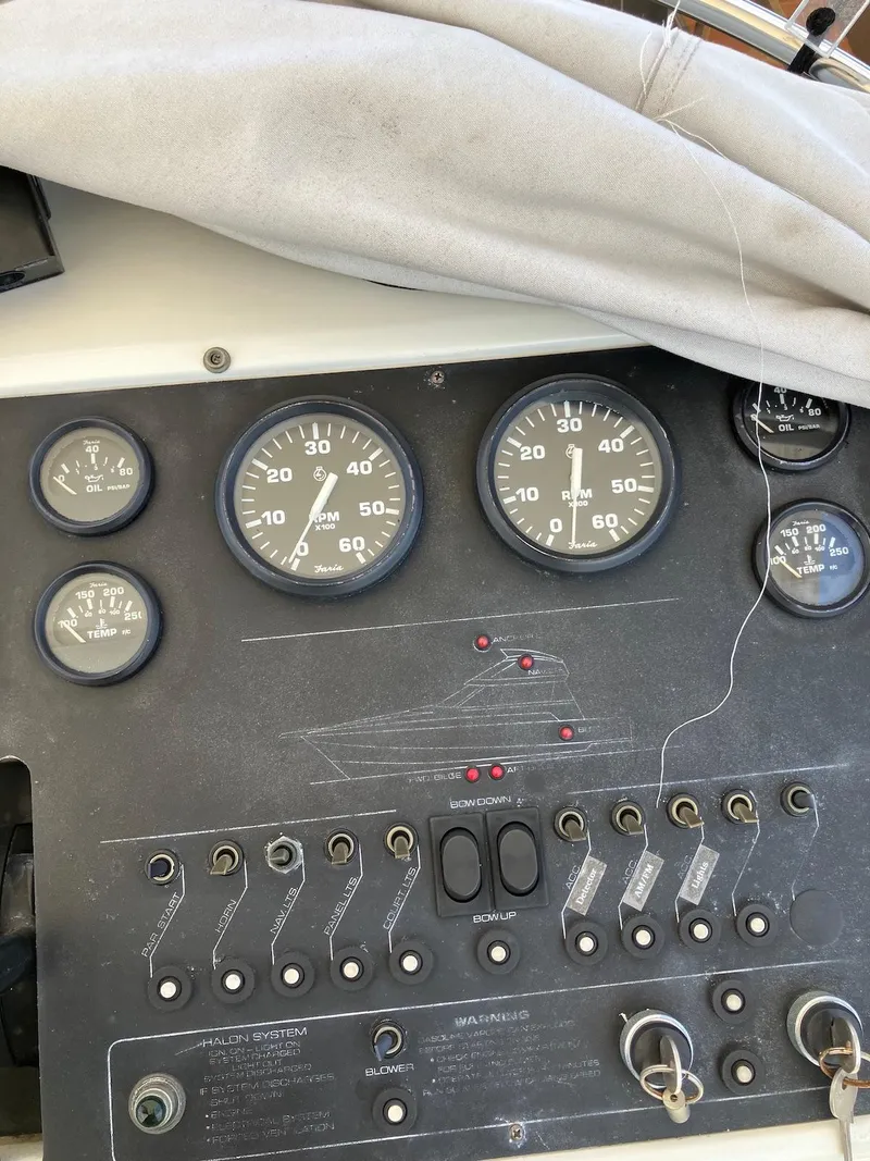Slide: The Image of 1992 Silverton 34 Convertible dashboard with gauges and switches. - 11