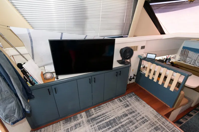 Slide: The Image of Interior of 1992 Silverton 34 Convertible with TV, cabinets, and modern decor. - 15