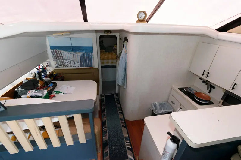 Slide: The Image of Interior of 1992 Silverton 34 Convertible yacht with kitchen and seating area. - 16