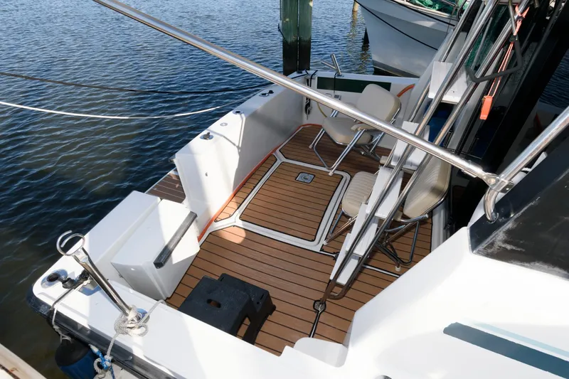 Slide: The Image of 1992 Silverton 34 Convertible boat deck with seating, docked on calm water. - 2