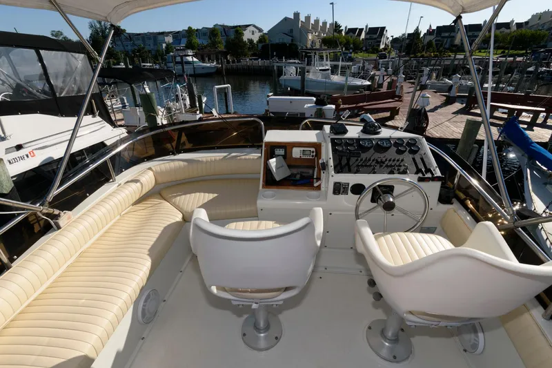 Slide: The Image of 1992 Silverton 34 Convertible boat interior with helm, seating, and marina view. - 4