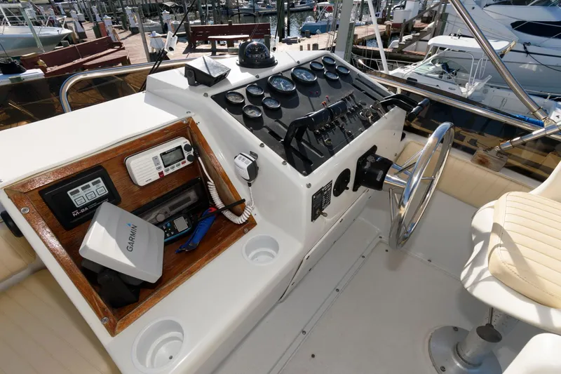 Slide: The Image of 1992 Silverton 34 Convertible boat dashboard with navigation instruments and steering wheel. - 6