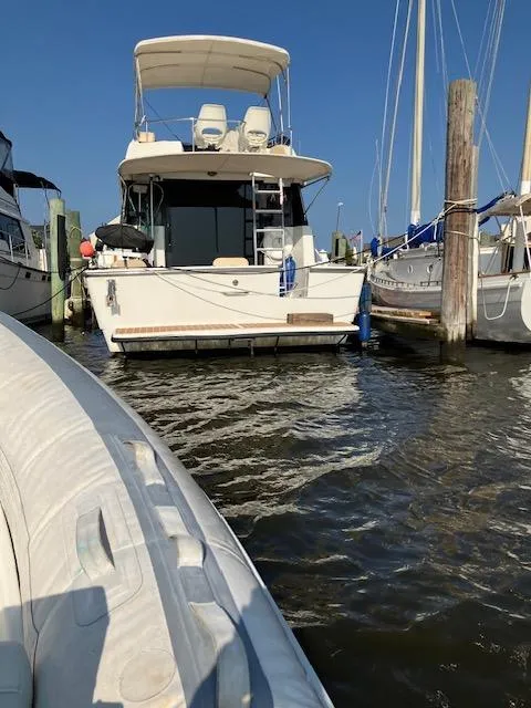 Slide: The Image of 1992 Silverton 34 Convertible yacht docked at marina, clear sky, calm water. - 9