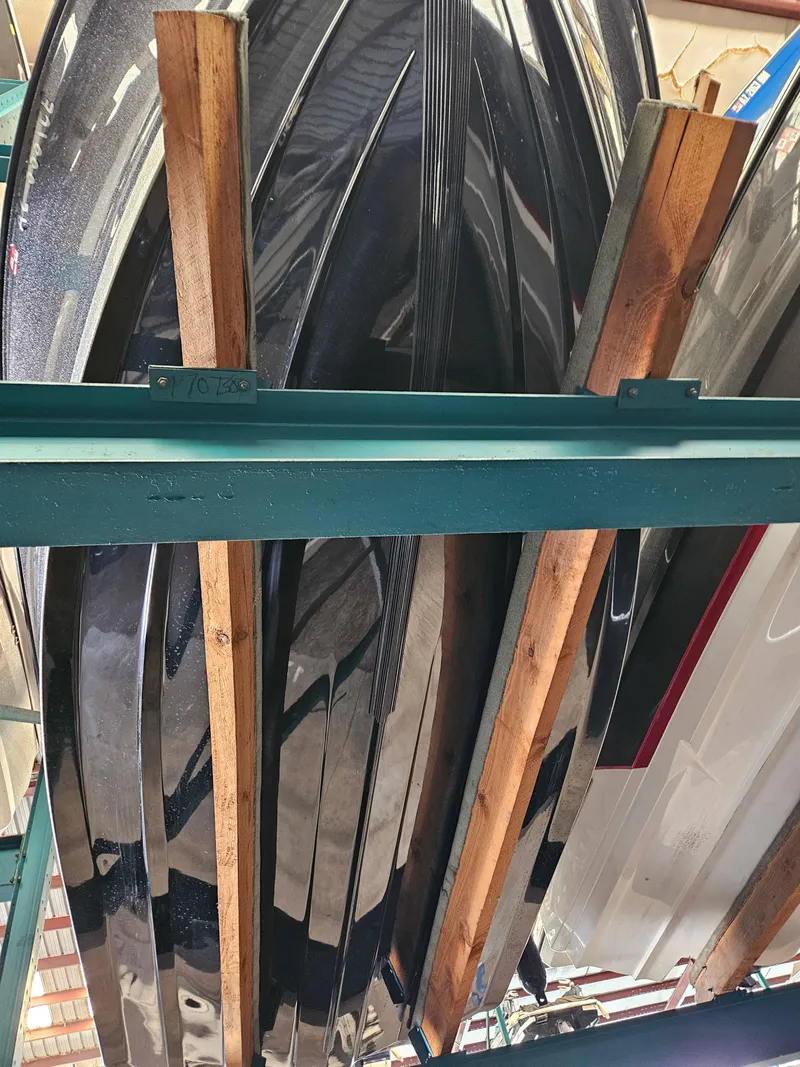 Slide: The Image of 2022 Lund TYEE boat hulls stored vertically in a warehouse. - 11