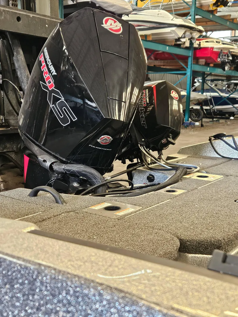 Slide: The Image of 2022 Lund TYEE boat with Mercury Pro XS outboard motors in storage. - 12