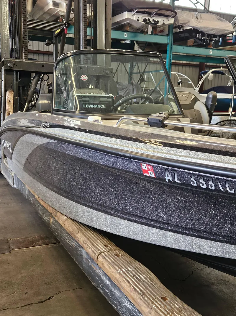 Slide: The Image of 2022 Lund TYEE boat in storage, featuring Lowrance equipment and visible registration numbers. - 5