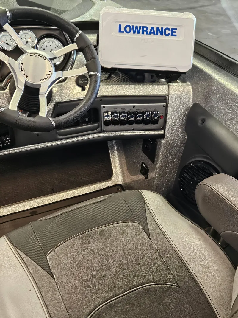 Slide: The Image of 2022 Lund TYEE boat dashboard with Lowrance GPS and steering wheel. - 7