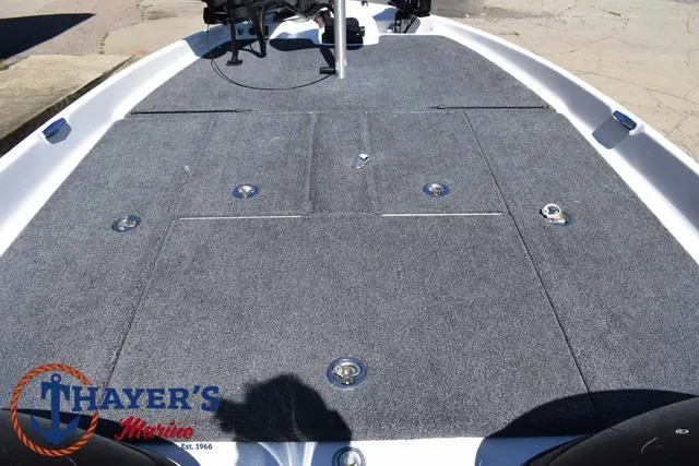 Slide: The Image of 2012 Bass Cat Pantera IV boat deck with gray carpet and storage compartments. - 16