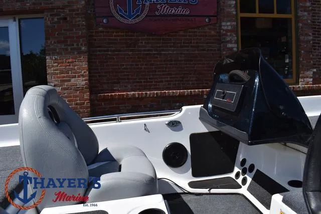 Slide: The Image of 2012 Bass Cat Pantera IV boat interior with gray seats and dashboard at Thayer's Marine. - 28