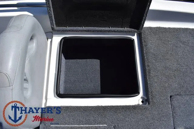 Slide: The Image of 2012 Bass Cat Pantera IV boat storage compartment with open lid, gray interior, and Thayer's Marine logo. - 40