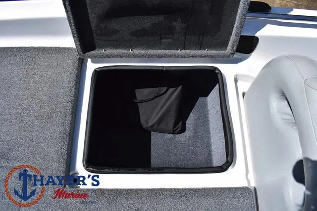 Slide: The Image of 2012 Bass Cat Pantera IV boat storage compartment with open lid, gray interior, and Thayer's Marine logo. - 41