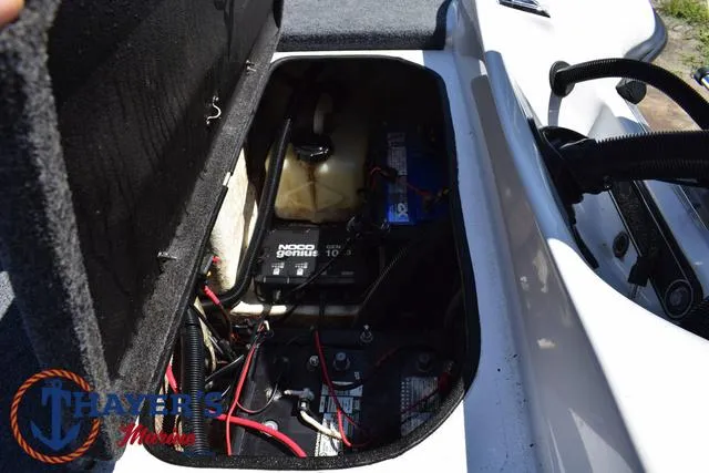 Slide: The Image of 2012 Bass Cat Pantera IV battery compartment with NOCO Genius charger and wiring. - 44