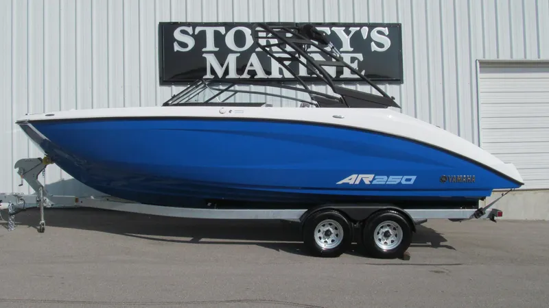 The Image of 2025 Yamaha AR250 boat in blue on trailer at Storey's Marine. - 0