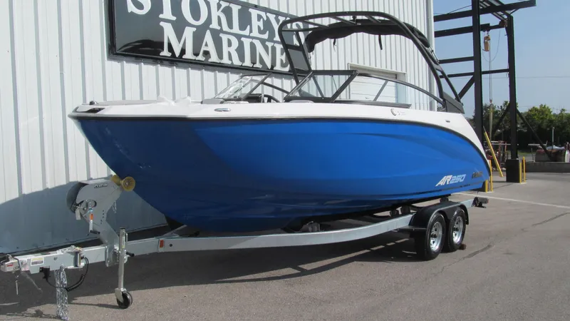 Slide: The Image of 2025 Yamaha AR250 boat in blue on a trailer at Stokley's Marine. - 1