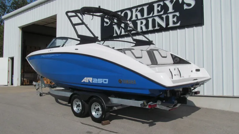 Slide: The Image of 2025 Yamaha AR250 boat on trailer outside Stokley's Marine. - 2