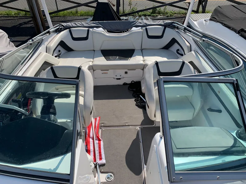 Slide: The Image of 2016 Yamaha Boats 190 SX interior with white seating and open cockpit design. - 2