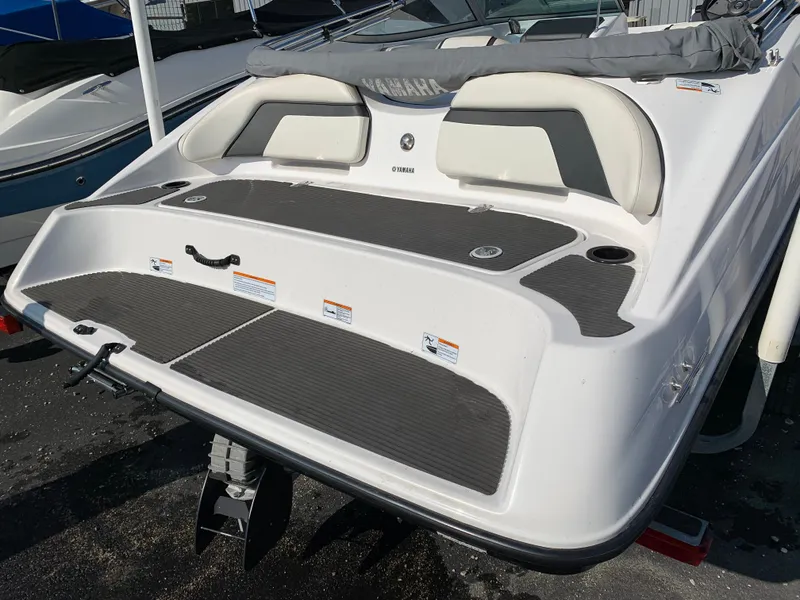 Slide: The Image of 2016 Yamaha Boats 190 SX, rear view, white and gray seating, docked. - 7
