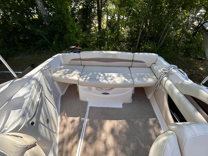 Slide: The Image of 2005 Chaparral 215 SSi boat interior with cushioned seating and carpeted floor. - 10