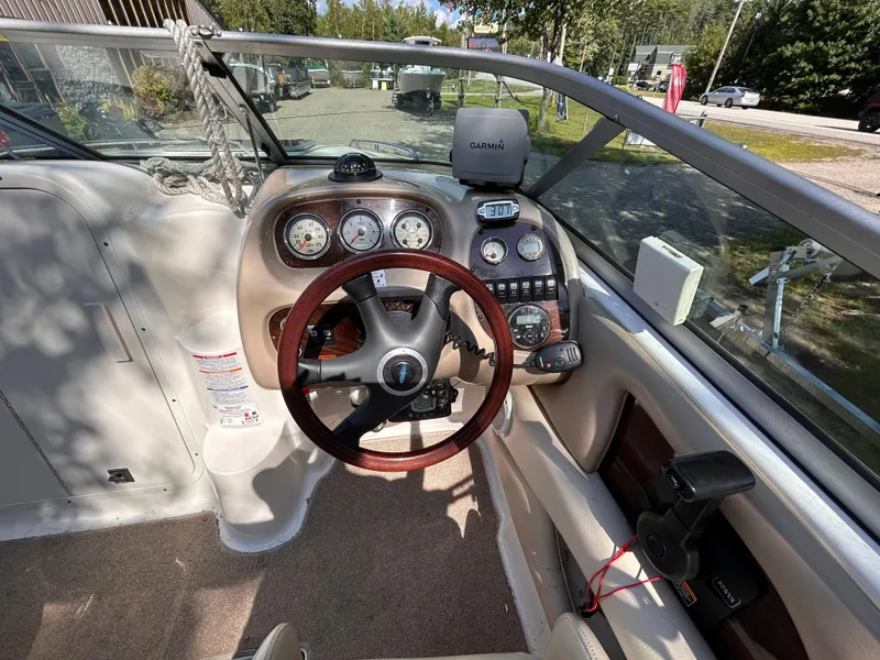 Slide: The Image of 2005 Chaparral 215 SSi boat dashboard with steering wheel and gauges. - 13