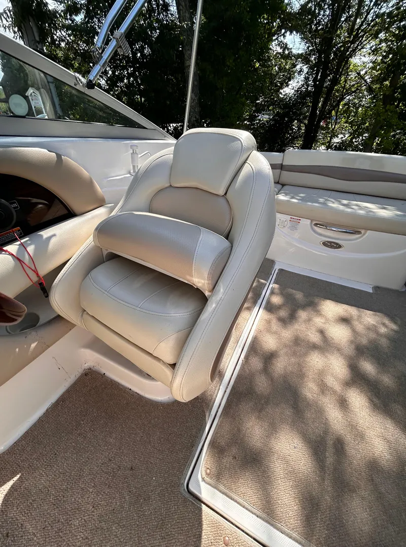 Slide: The Image of 2005 Chaparral 215 SSi boat interior with beige seating and carpeted flooring. - 14