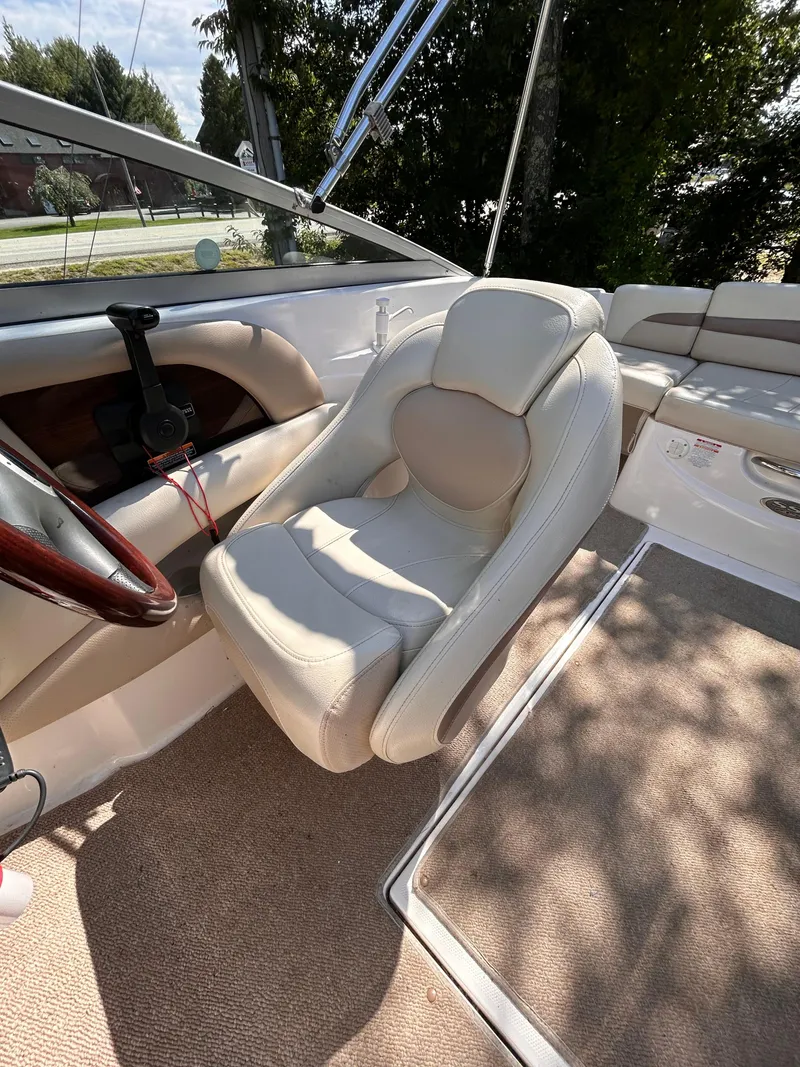 Slide: The Image of 2005 Chaparral 215 SSi boat interior with plush seating and steering wheel. - 15