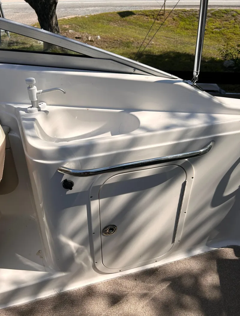 Slide: The Image of 2005 Chaparral 215 SSi boat interior with sink and storage compartment. - 16