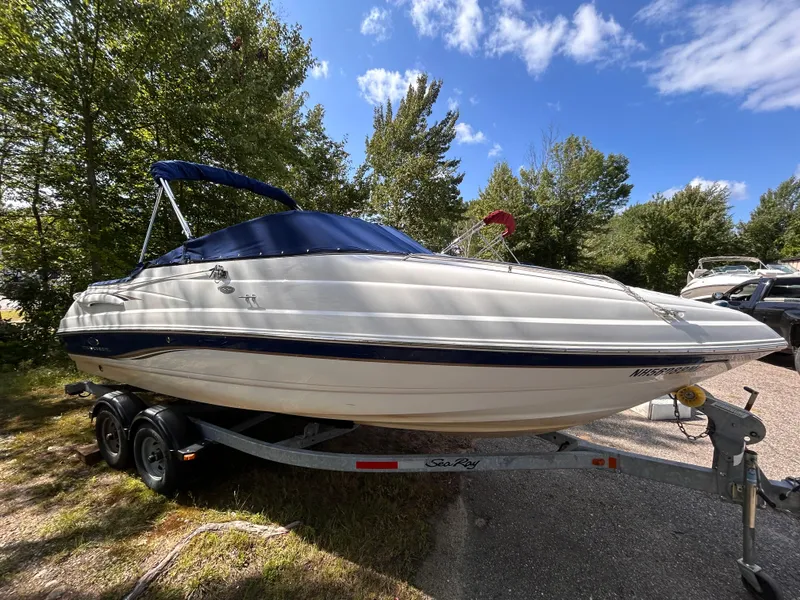 Slide: The Image of 2005 Chaparral 215 SSi boat on trailer, parked outdoors under a blue sky. - 3